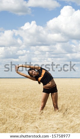 a beauty young woman training over sky background