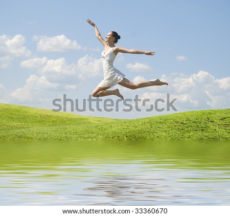 young jumping woman against nature background