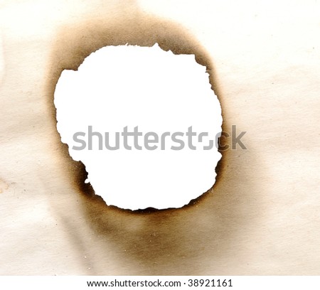 close up view of burnt hole in a paper