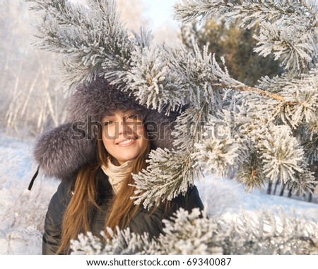 young pretty woman in winter forest