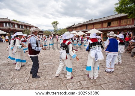 LIJIANG,CHINA -APRIL 17 : Naxi people do the traditional dance at Sifang square the center of Lijiang old town on April 17, 2008 in Lijiang city - Yunnan province China.