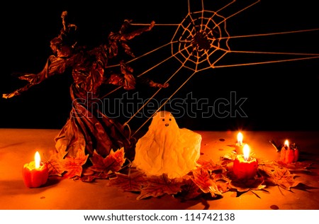 Halloween pumpkin and ghost under spooky tree