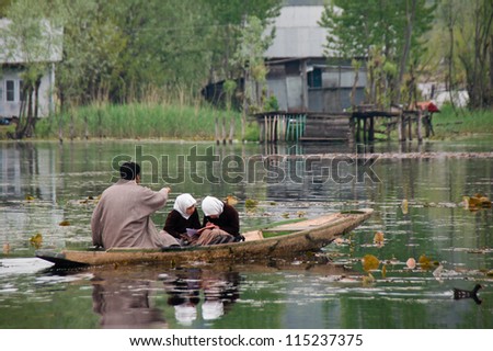 SRINAGAR,INDIA -APRIL 14:Kashmiri girls ride the boat to school, local people have to use a boat for transportation in the lake on April 14,2012 in Dal Lake Srinagar,Jammu and Kashmir-India.