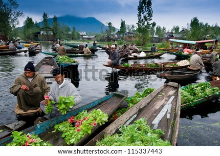 SRINAGAR,INDIA -APRIL 14: Lifestyle in Dal lake,Kashmiri men sell their vegetables at a floating market in the early hours before sunrise on April 14,2012 in Dal Lake, Srinagar,Jammu & Kashmir, India.