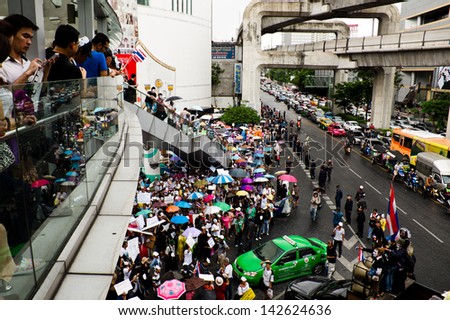 BANGKOK,THAILAND-JUNE16:About1,000protesters wear white Guy Fawkes masks rally from the CentralWorld shopping complex,gathering at The Bangkok Art and Culture Centre on June16,2013 in Bangkok Thailand