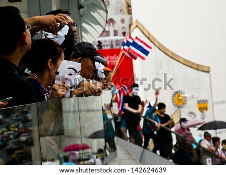 BANGKOK,THAILAND-JUNE16:About1,000protesters wear white Guy Fawkes masks rally from the CentralWorld shopping complex,gathering at The Bangkok Art and Culture Centre on June16,2013 in Bangkok Thailand