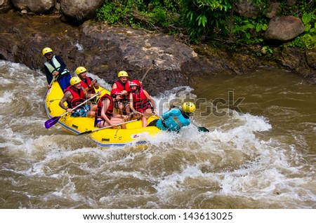 PHANG NGA,THAILAND-DEC 6:Group of tourists enjoy white water rafting on river at Song prack village on December 6,2011 in Phang nga Thailand.Here is the most popular rafting point in South of Thiland.