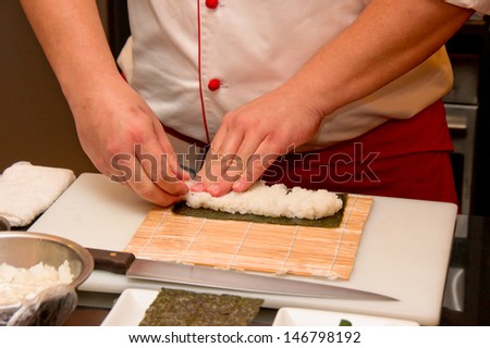 Closeup of Japanese chef making Japanese sushi rolls
