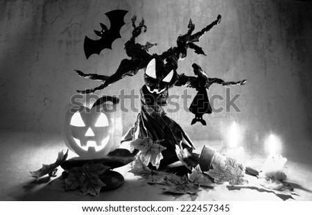Halloween pumpkin under spooky tree with creepy bats(black and white background )