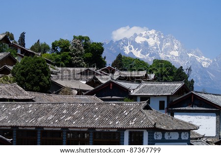 Ancient roof in Lijiang old town with Snow mountain background