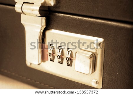 old and used suitcase with combination lock security