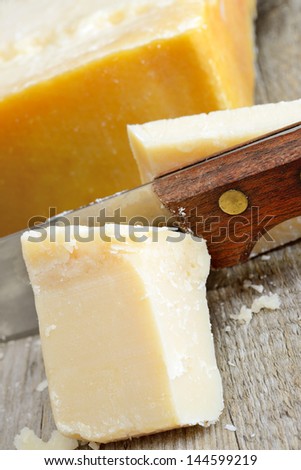 authentic piece of  Parmesan italian cheese on wooden table