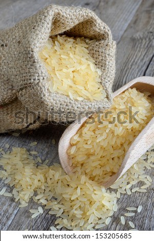 polished rice in bag ideal for salads and spade on wooden table