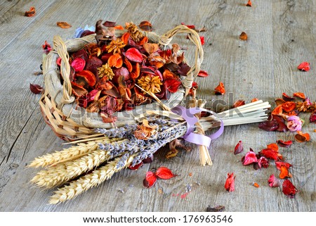 wooden table with items for makeup and fragrant flowers dried