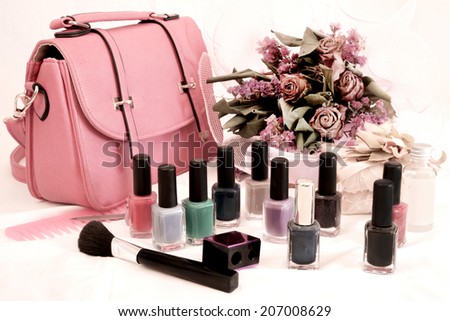 desatured effect bags and nail polish with dried flowers - filtered image