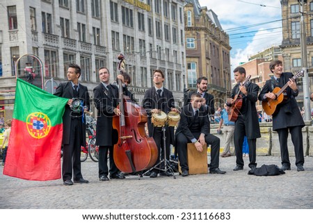 AMSTERDAM, AUGUST 4: large group of street performers improvise a live concert in the DAM square on August 4, 2014 in Amsterdam
