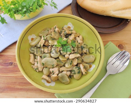 Stewed lima beans with fried chicken breast and parsley.