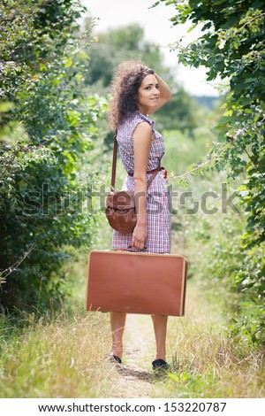 Off to elsewhere: beautiful young woman about to leave to a next destination