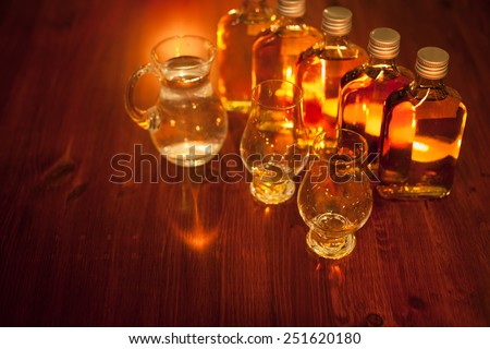 Whiskey tasting: sample bottles, glencairn glasses and a jug of water