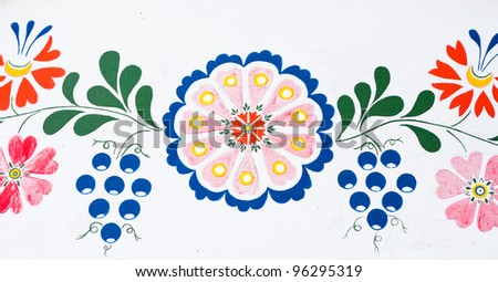Flowers and grapes: closeup of traditional colorful folk painting on the walls of a wine cellar (Petrov, winemaking region in Southern Moravia, Czech Republic)