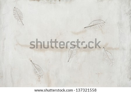 Texture of plastered wall with impressed leaf