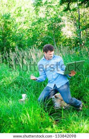 Super happy man in the forest with a laptop... it's a sucess !
