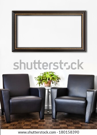 Modern Interior Room and white wall and big empty Painting Frame with space for your text. Two luxurious couch and glass table with accessories of your choice.