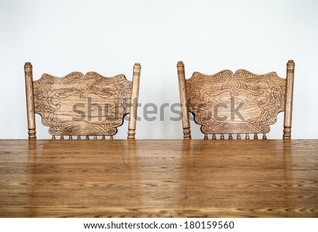 Wooden Dining room table and chair details and blank wall for your text, image or logo.