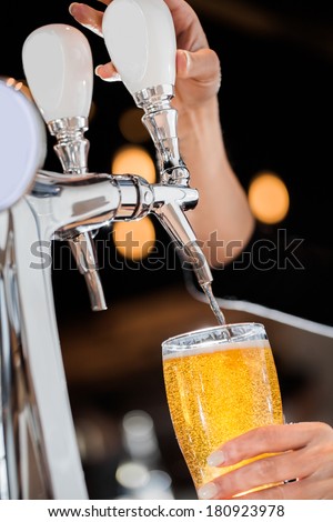 Pouring a Draft Blonde Beer in a Pint Directly from the Tap