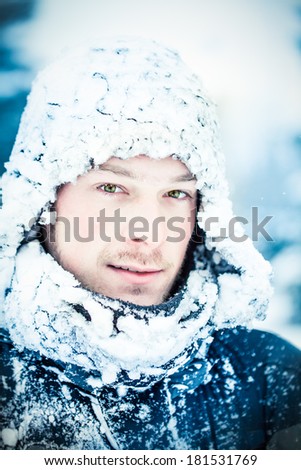 Young Adult man with Green Eyes During an Expedition in the North on a Freezing Winter Day
