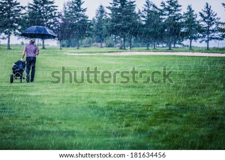Golfer on a Rainy Day Leaving the Golf Course (the game is annulled because of the storm)