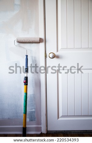 Closeup of a Paint Roller on the Wall