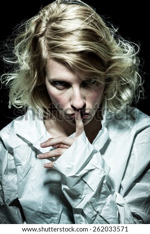 Psycho Woman asking for Silence with Finger on Lips
