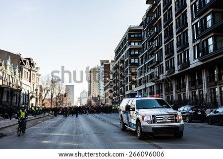 MONTREAL, CANADA   APRIL 02 2015: Riot in the Montreal Streets to counter the Economic Austerity Measures. Police Pick-up Truck in front of the Protesters controlling the Traffic
