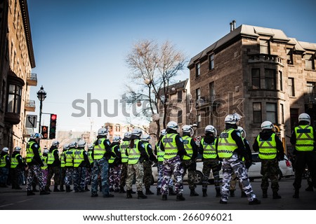 MONTREAL, CANADA   APRIL 02 2015: Riot in the Montreal Streets to counter the Economic Austerity Measures. Cops making a line to Control the Protesters