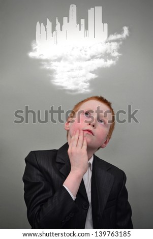 Young redhead boy dreams of the future