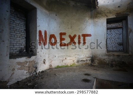 text no exit  on the dirty old wall in an abandoned ruined house
