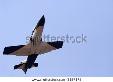 Airplane doing a show in the sky. The right zone of the picture is deliberated left black to use with the same blue sky as the fighter.