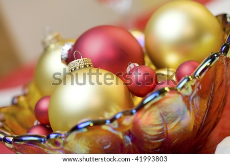 Red and gold ornaments in bowl