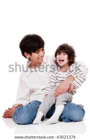 Two brothers laughing together, both are of part Asian - Scandinavian descent. Little brother has cerebral palsy.