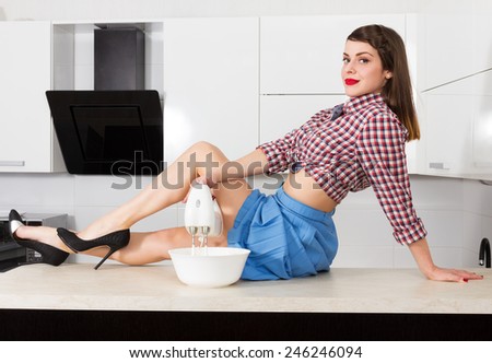 Stylish pin up housewife in her kitchen