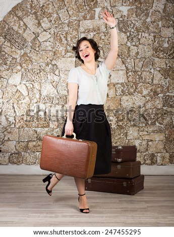 Beautiful woman with suitcases ready for trip