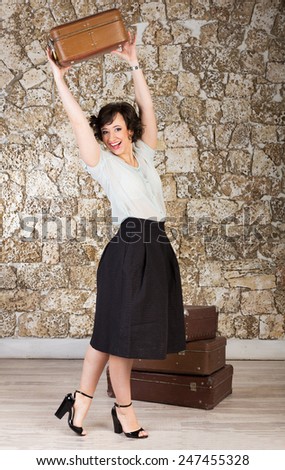 Beautiful woman with suitcases ready for trip