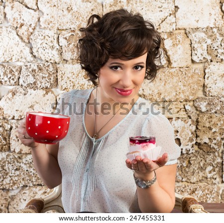 Beautiful woman with a cake and tea