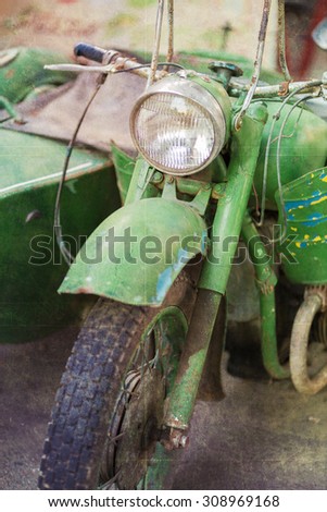 Green vintage motorbike headlamp. Retro textured image