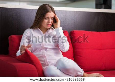 Young woman suffering from the sudden pain
