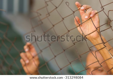 A man breaking down the fence. Immigration concept