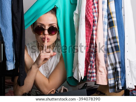 Young hipster woman sorting her wardrobe