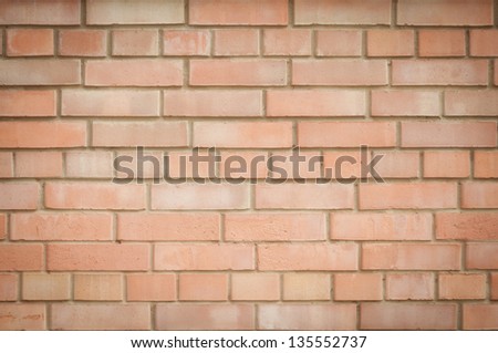 Wall of red brick. Background neat beautifully laid brick.
