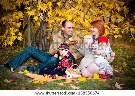 Family picnic. Family of four in the autumn forest